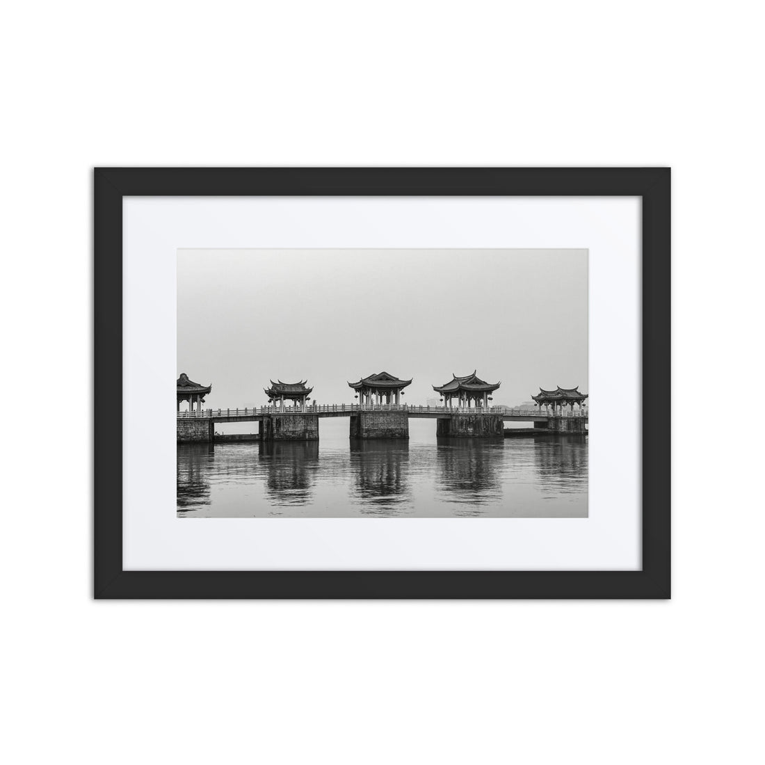 Black and white framed poster of traditional Asian bridge over calm water, modern decor